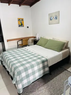 a bedroom with a bed with a checkered blanket at Hogar De Ensueño in Envigado