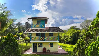 a house with a tower on top of it at Casa de 7 habitaciones cerca al pueblo de Guatapé in Guatapé