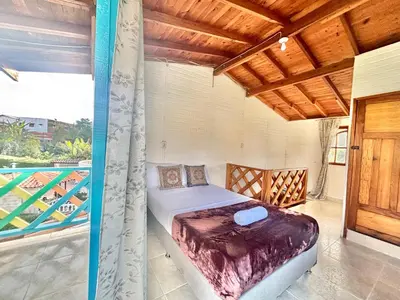 a bedroom with a bed on a balcony at Casa de 7 habitaciones cerca al pueblo de Guatapé in Guatapé