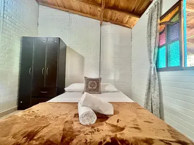 a bedroom with a bed with two pillows on it at Casa de 7 habitaciones cerca al pueblo de Guatapé in Guatapé