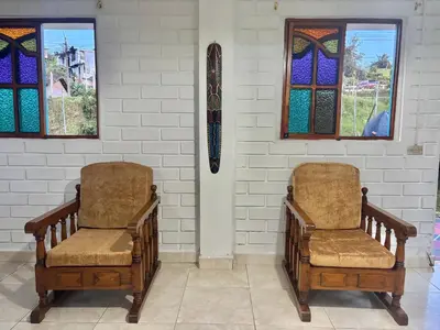 two chairs in a room with stained glass windows at Casa de 7 habitaciones cerca al pueblo de Guatapé in Guatapé