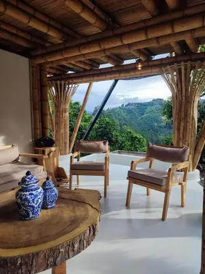 a room with chairs and a table with a view at Leaf House - Sereno Glamping in El Tablazo