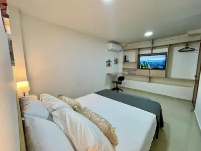 a bedroom with a bed and a flat screen tv at laureles zona turistica estadio cerca poblado aire acondicionado in Medellín