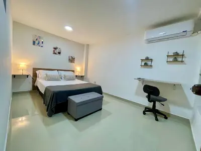 a bedroom with a bed and a desk and a chair at laureles zona turistica estadio cerca poblado aire acondicionado in Medellín