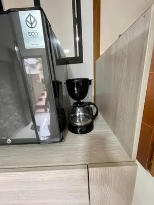 a coffee maker is sitting on a shelf at laureles zona turistica estadio cerca poblado aire acondicionado in Medellín