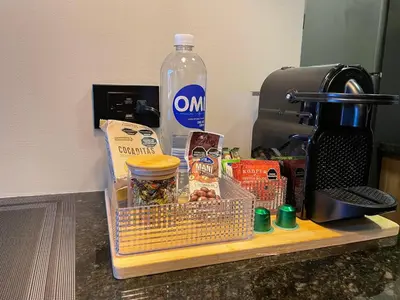 a counter with a container of food and a bottle of water at Premium Studio near Oviedo Mall, El Poblado- Balcony, AC & Fast WiFi in Medellín