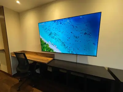 a large flat screen tv hanging on a wall at Premium Studio near Oviedo Mall, El Poblado- Balcony, AC & Fast WiFi in Medellín