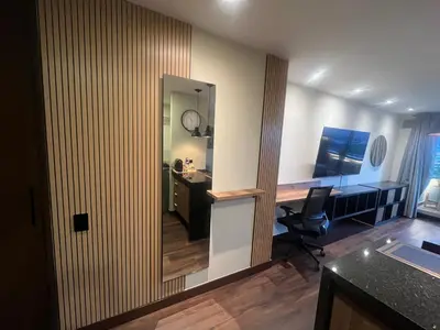 an office with a mirror and a desk and a chair at Premium Studio near Oviedo Mall, El Poblado- Balcony, AC & Fast WiFi in Medellín