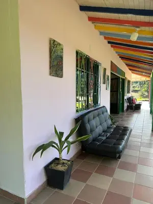 a black couch sitting in the middle of a building at Refugio del Atardecer in El Peñol