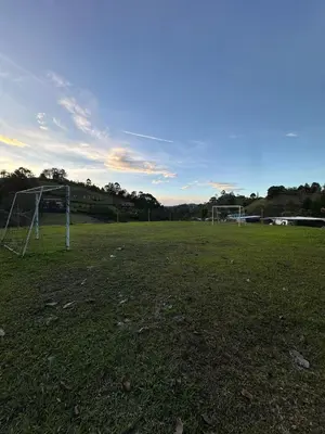 an empty field with a soccer goal in a field at Refugio del Atardecer in El Peñol