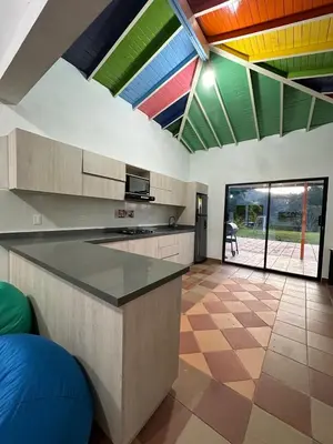 a kitchen with colorful ceilings and a large island at Refugio del Atardecer in El Peñol