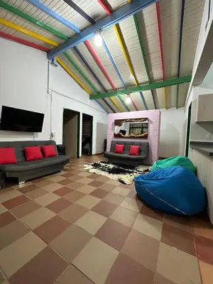 a living room with couches and a colorful ceiling at Refugio del Atardecer in El Peñol
