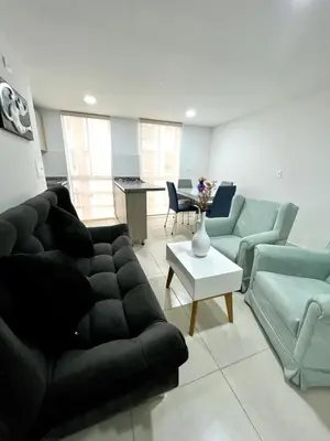 a living room with a couch and a table at Espectacular apartamento in Manizales