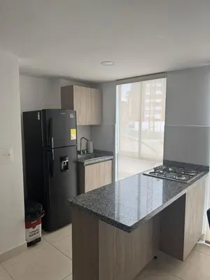 a kitchen with a black refrigerator and a counter top at Espectacular apartamento in Manizales