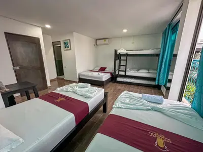 two beds in a room with two bunk beds at HOTEL COLONIAL santorini colombiano in Doradal