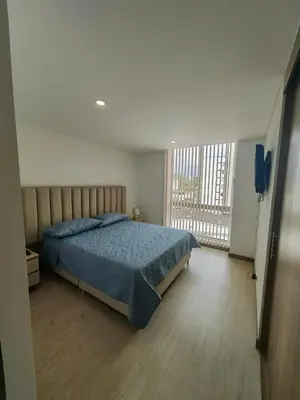 a bedroom with a bed and a large window at Modern and Cozy Las Camelias in Manizales