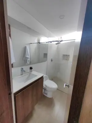 a white bathroom with a toilet and a sink at Modern and Cozy Las Camelias in Manizales