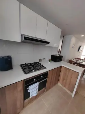 a kitchen with a stove and a white counter top at Modern and Cozy Las Camelias in Manizales