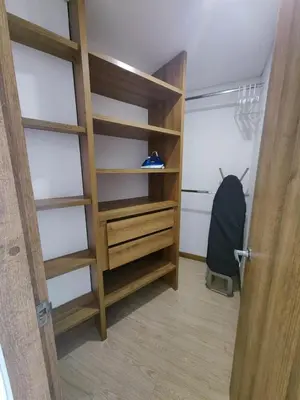 a room with a closet with wooden shelves at Modern and Cozy Las Camelias in Manizales