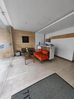 a living room with a couch and a table at Modern and Cozy Las Camelias in Manizales