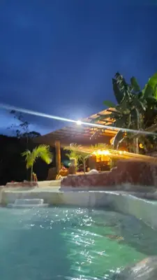a swimming pool at a resort at night at Hotel Pekin in San Carlos
