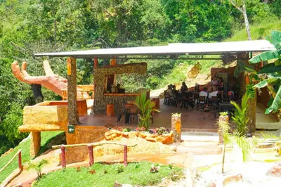 a group of people sitting at a restaurant under a pavilion at Hotel Pekin in San Carlos