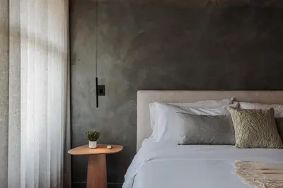 a bedroom with a bed with a table next to it at 10th Street Three-Bedroom Jacuzzi & Billiard 201 in Medellín