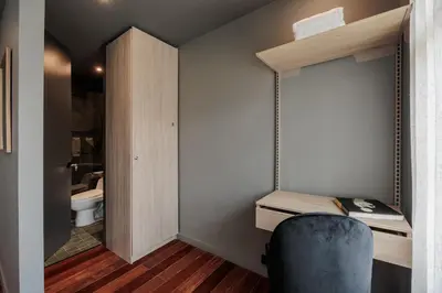 a small room with a desk and a blue chair at 10th Street Three-Bedroom Jacuzzi & Billiard 201 in Medellín