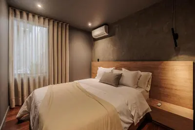 a bedroom with a large bed and a window at 10th Street Three-Bedroom Jacuzzi & Billiard 201 in Medellín