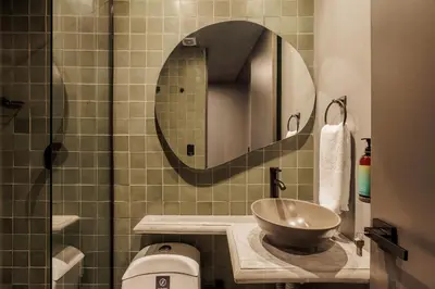 a bathroom with a bowl sink and a mirror at 10th Street Three-Bedroom Jacuzzi & Billiard 201 in Medellín