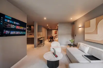 a living room with a white couch and a table at 10th Street Three-Bedroom Jacuzzi & Billiard 201 in Medellín