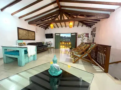 a living room with a table and a couch at Blomst Casa Hostal in Jericó