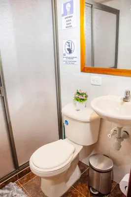 a bathroom with a toilet and a sink at Blomst Casa Hostal in Jericó