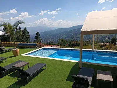 a swimming pool with a view of the mountains at VIVE PARADISE - UNICA HOSTERIA TERMAL Only Adult a solo 15 minutos de la ciudad in Medellín
