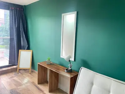a room with a mirror and a table and a chair at Estudio renovado Belén, ubicación e iluminación in Medellín
