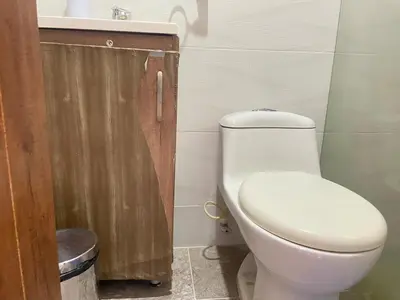 a bathroom with a white toilet and a sink at Estudio renovado Belén, ubicación e iluminación in Medellín