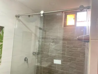 a bathroom with a shower with a glass door at Estudio renovado Belén, ubicación e iluminación in Medellín