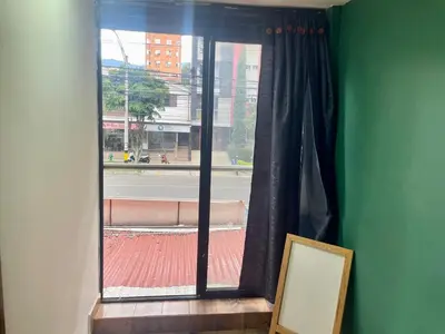 a room with a window with a picture and a mirror at Estudio renovado Belén, ubicación e iluminación in Medellín