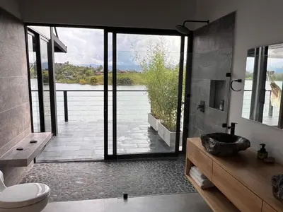 a bathroom with a view of the water at Villa de lujo frente a la represa del Peñol in El Peñol