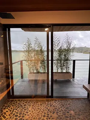 a glass door with a view of the water at Villa de lujo frente a la represa del Peñol in El Peñol