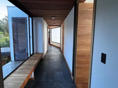 a hallway of a house with wooden floor and windows at Villa de lujo frente a la represa del Peñol in El Peñol