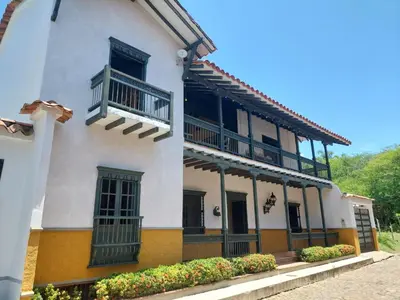 a white building with balconies on the side of it at Espectacular Casa en Cauca viejo con piscina, jacuzzi y turco in Jericó
