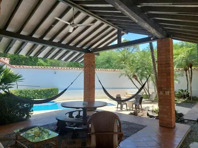 a patio with a hammock and a pool at Espectacular Casa en Cauca viejo con piscina, jacuzzi y turco in Jericó