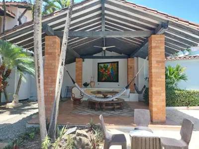 a patio with a hammock under a pergola at Espectacular Casa en Cauca viejo con piscina, jacuzzi y turco in Jericó