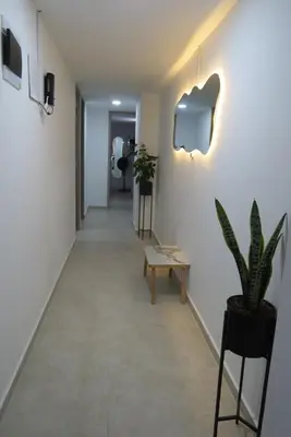 a hallway with a bench and a potted plant at Acogedor apto in Sabaneta
