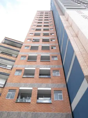 a tall brick building with windows on the side of it at Acogedor apto in Sabaneta