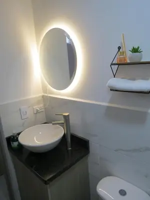 a bathroom with a sink and a mirror at Acogedor apto in Sabaneta