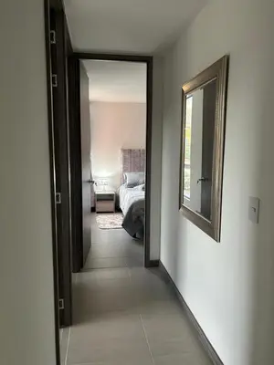 a hallway with a mirror and a bed in a bedroom at Apartamento Moderno con piscina en Medellín Itagüí - sur in Estación El Salto