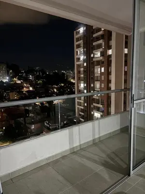 a balcony with a view of a city at night at Apartamento Moderno con piscina en Medellín Itagüí - sur in Estación El Salto