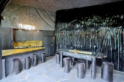 a kitchen with stools and a wall with a painting at Luxury Villa Eleven Eleven in San Rafael